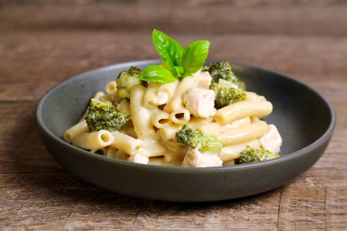 Rigatoni pasta is tubular in shape and loved for its ability to hold sauces and grated cheese on its ridges. It resembles penne but with square-cut ends and often slightly curved. Rigatoni is the favorite pasta shape in the south of Italy and Sicily. It is perfect with any sauce, from cream to the chunkiest meat sauces.